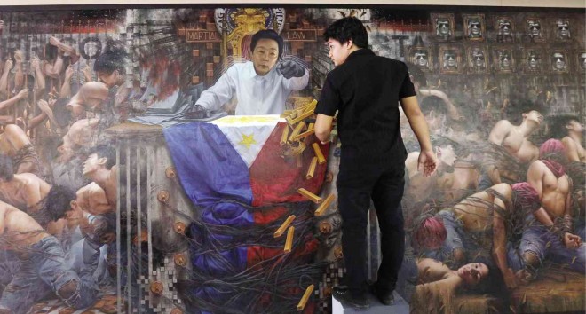 FACE-TO-FACE WITH MARTIAL LAW MEMORIES Authoritarian President Ferdinand Marcos seems to be confronting young Batanes artist Randalf Dilla in this mural titled “Salvaged Memories, Salvaged Lives.” The oil and acrylic mural was commissioned by Hiraya Gallery to remind Filipinos of the horrors of martial law. It is part of the exhibit “Tyranny of Hindsight,” which opens on Sept. 23 in connection with the 43rd anniversary of the declaration of martial rule. Dilla, 28, was not yet born at the time, but assiduous research gave him enough insight into what he described as a reality that should not be forgotten or rewritten. MARIANNE BERMUDEZ