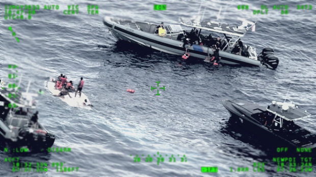 Rescue craft arrive on scene after a migrant vessel capsized north of Desecheo Island, Puerto Rico May 12, 2022 in a still image from surveillance aircraft video.  United States Coast Guard/Handout via REUTERS