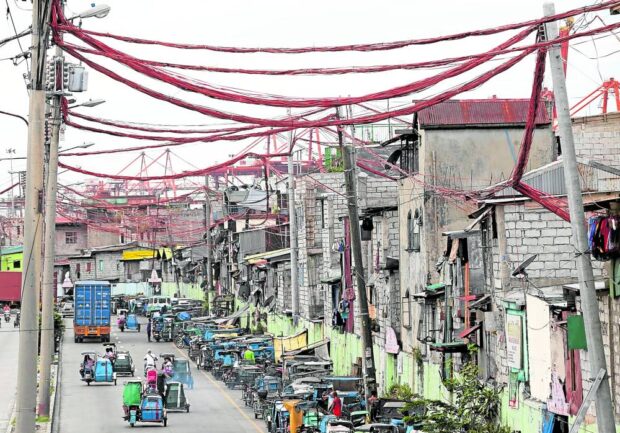 Electrical lines stretching over and in between houses of informal settlers in Barangay 20, Parola, Tondo. An additional subsidy is being proposed to help them cope with higher inflation. STORY: P418-million power subsidy for poor families sought