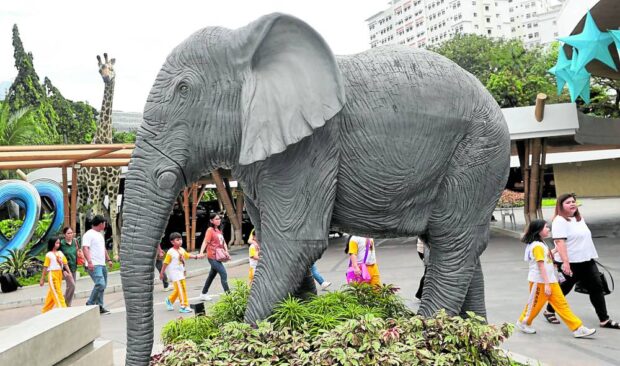 FAREWELL TO MALI Children on a field trip to Manila Zoo walk past a statue of an elephant, a tribute to the zoo’s longest and most popular resident Mali, who died suddenly on Tuesday afternoon after decades of solitary living. Animal rights group Peta lamented her death, saying that because of indifference and greed, she died as she had lived: “alone in a barren concrete pen.”—MARIANNE BERMUDEZ