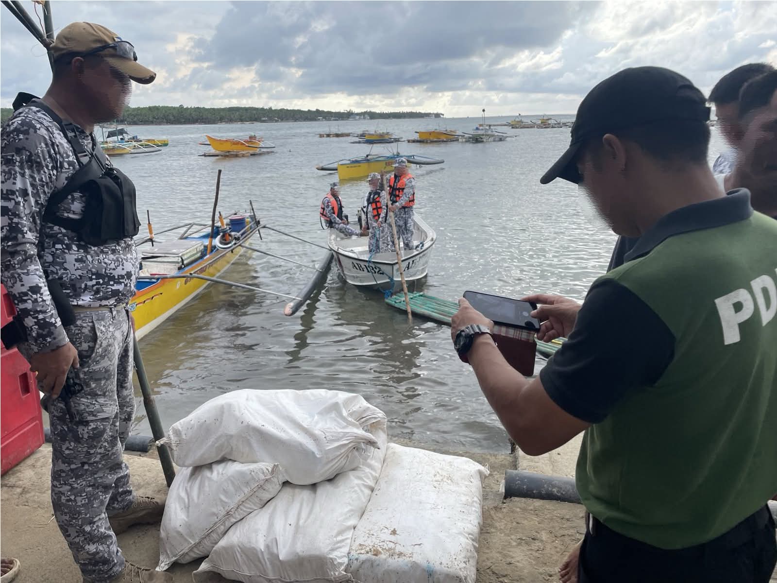Philippine Coast Guard personnel recover sacks of shabu from Pangasinan shores.